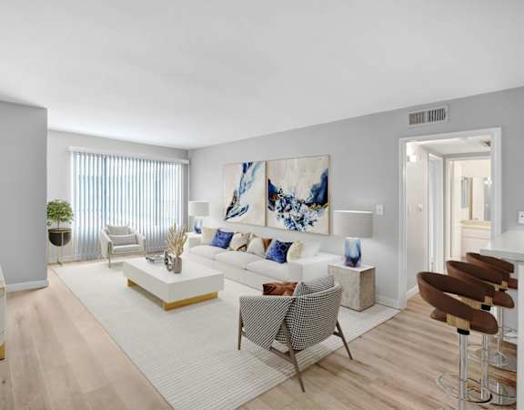 a living room with a white couch and a white rug