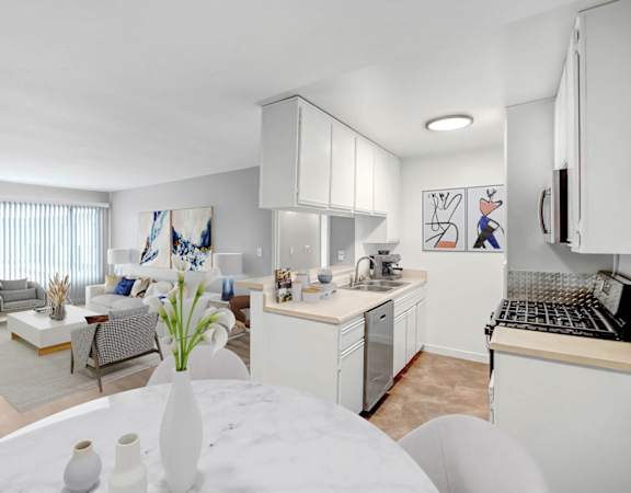 a kitchen and living room with a table and a sink