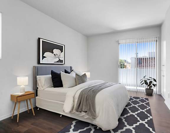 a bedroom with a large bed and a large window