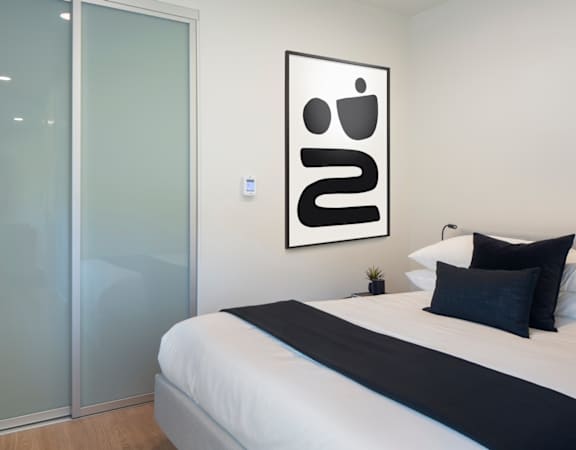 a bedroom with a bed and a glass door