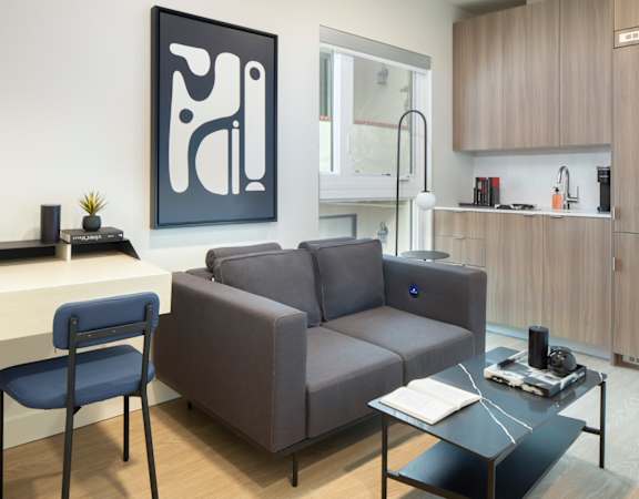 a living room with a gray couch and a coffee table