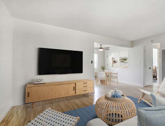 A living room with a television, chairs, and a table.