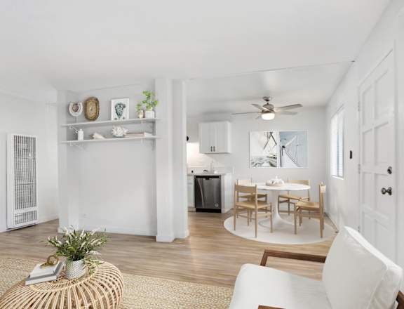 A white living room with a dining table and chairs.