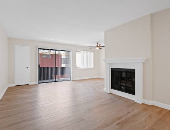 a living room with hardwood floors and a fireplace