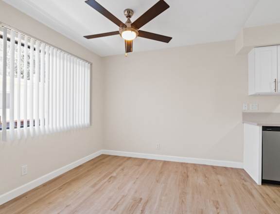 a bedroom with hardwood floors and a ceiling fan