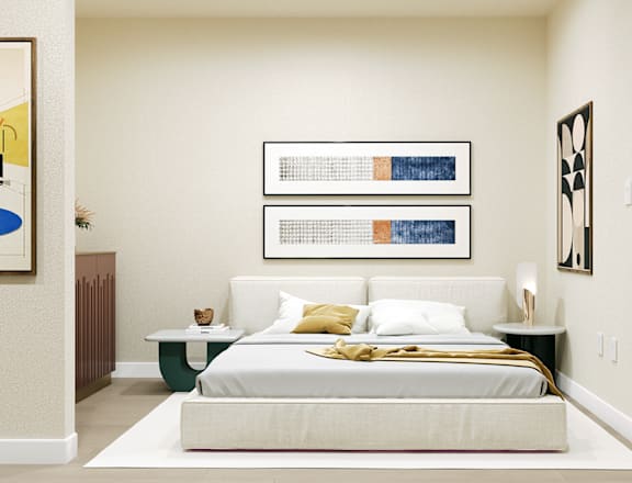 A bedroom with a bed, nightstand, and two framed pictures on the wall.