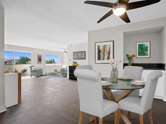 A dining room with a glass table and chairs.