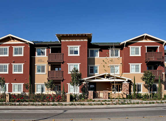 Apartment building with red brick and white trim.