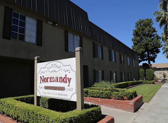 A Normandy sign is in front of a building.