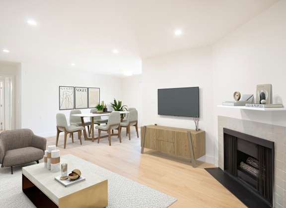 a living room with a fireplace and a table with chairs