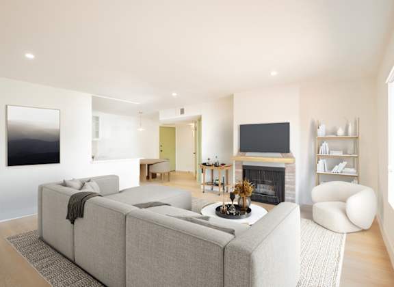 a living room with a gray couch and a fireplace