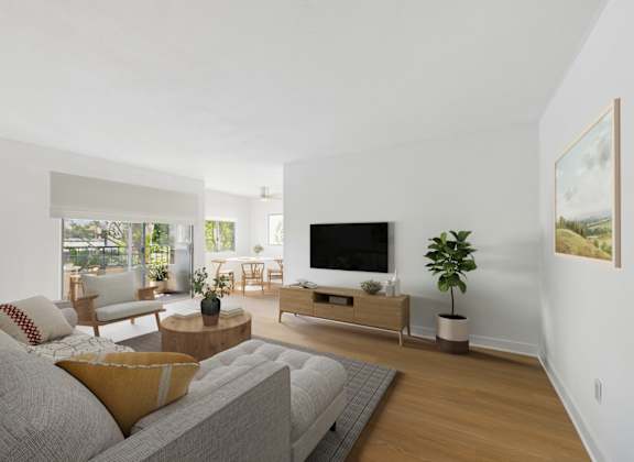 A living room with a grey couch and a wooden coffee table.