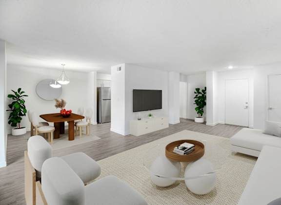 a living room with white furniture and a television