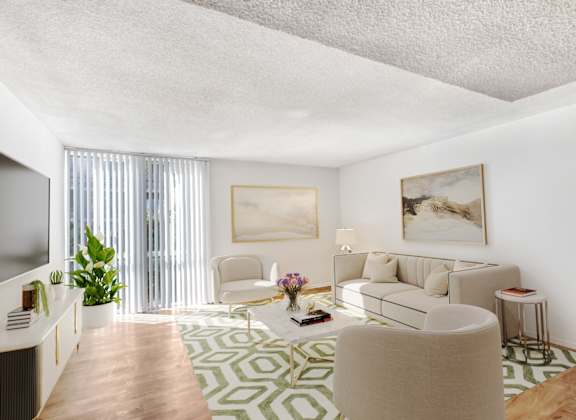 A living room with a white couch, a green and white rug, and a painting on the wall.