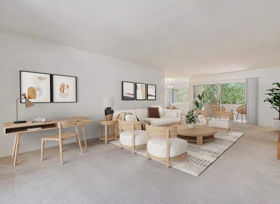 A living room with a white couch, a wooden table, and a rug.