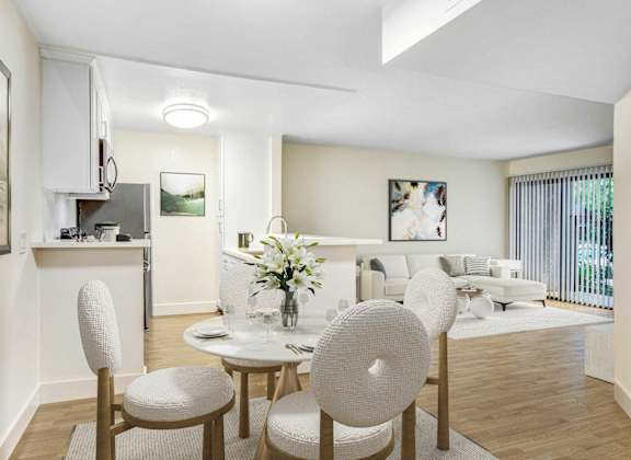 a living room and dining room with a table and chairs
