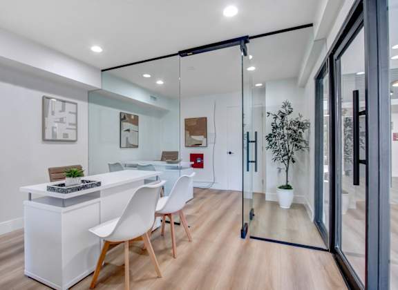 a dining area with a table and chairs and a sliding glass door