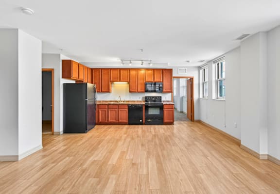 A kitchen with wooden floors and white walls.