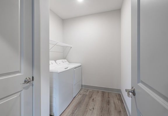 A white laundry room with a washer and dryer.