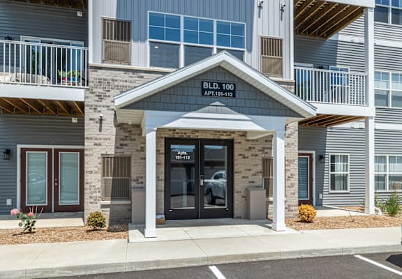 The front entrance of a building with a sign that reads "BLDG. 100".