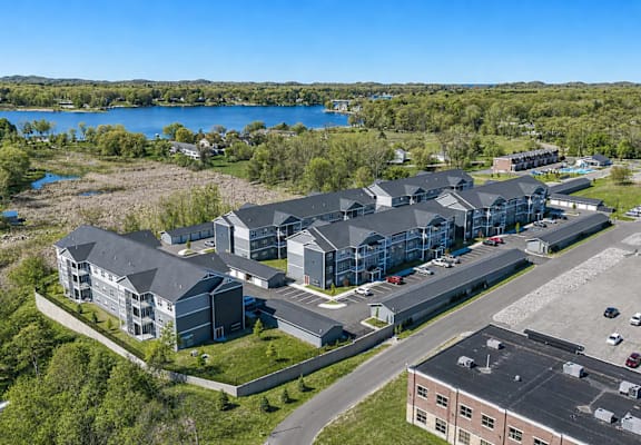 A large building complex with a parking lot in front.