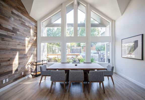 A dining room with a wooden table and chairs.