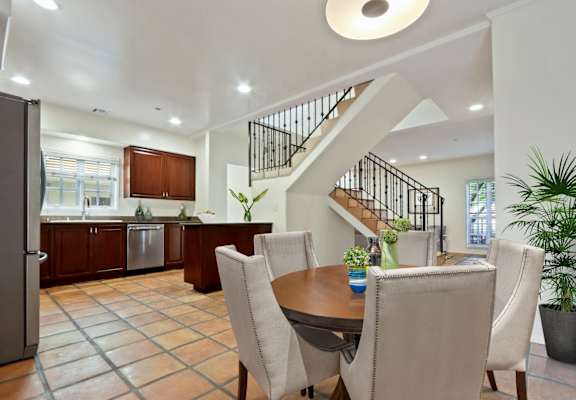 a dining room with a table and chairs and a staircase