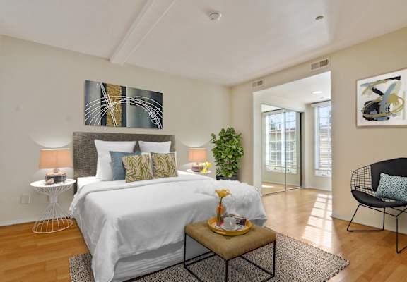 a bedroom with a large bed and a door to a balcony