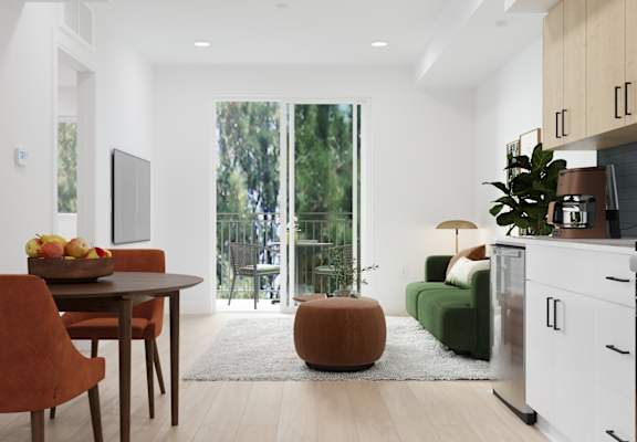 A modern kitchen with a dining table and chairs.