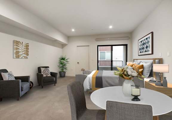 a bedroom with a bed and a table in a room