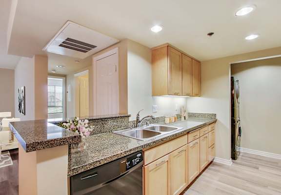 a kitchen with granite counter tops and a sink