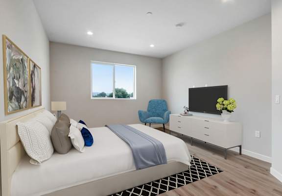 a bedroom with a bed and a tv in a room