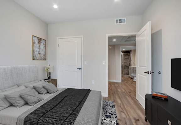 a bedroom with a large bed and a tv
