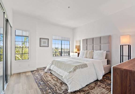 a bedroom with a large bed and a window
