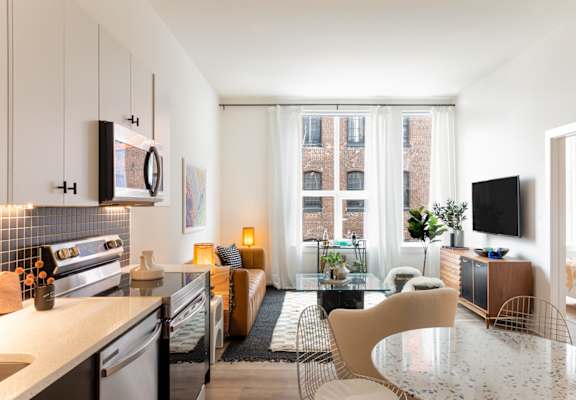 a kitchen and living room in a 555 waverly unit