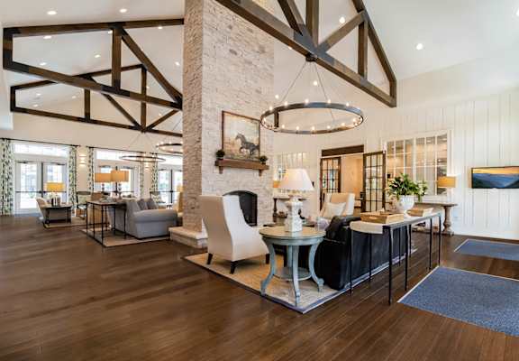 Clubhouse living room view of Alexander Village with round chandelier