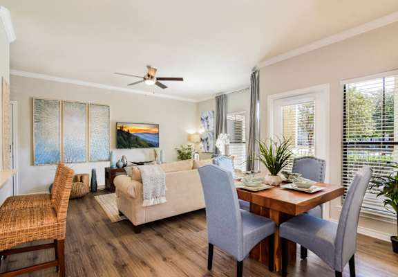 a living room and dining room with a couch and a table