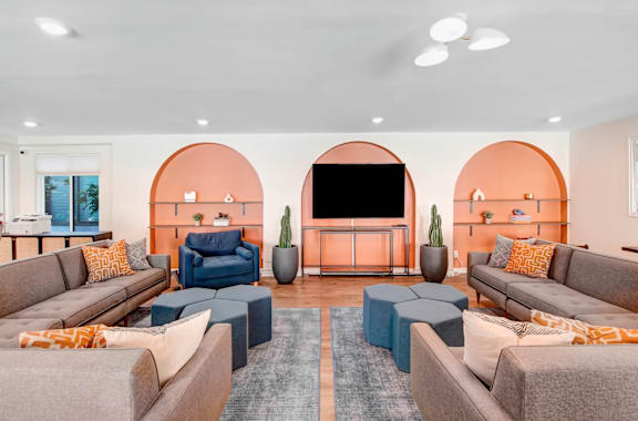 a living room with couches and chairs and a television