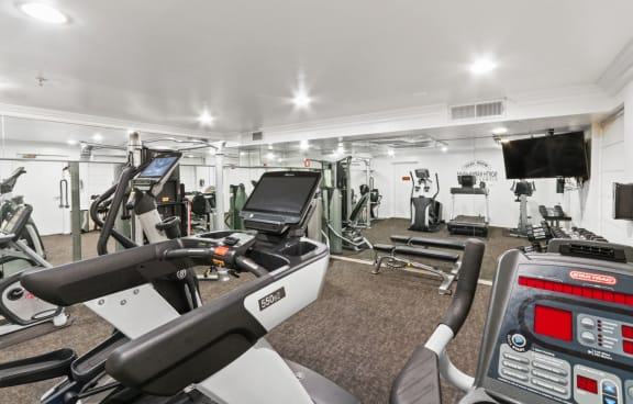 a gym with treadmills and other exercise equipment