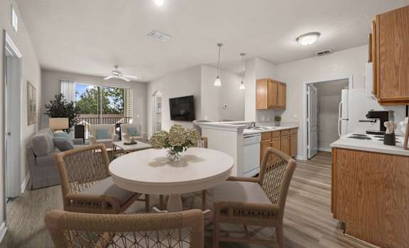 A kitchen with a table and chairs in the middle of the room.