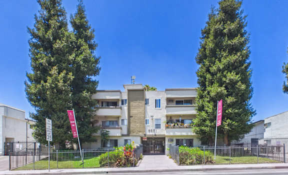 A modern building with a flag on the left and right side.