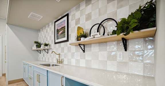 A kitchen with blue cabinets and a white countertop.