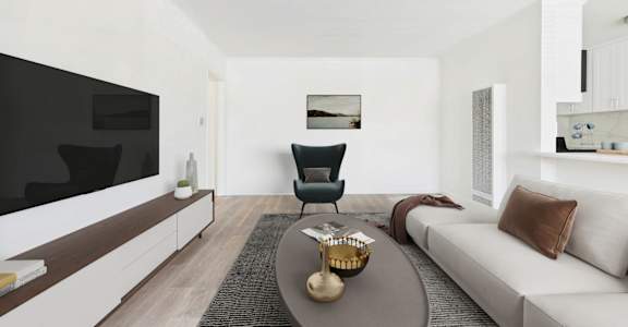 A modern living room with a white sofa, a black chair, and a coffee table.