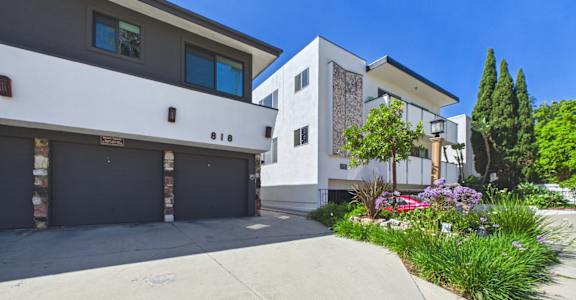 A modern two-story house with a garage and a driveway.