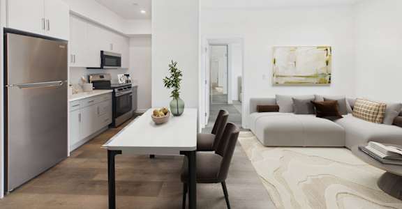 A modern kitchen with a dining table and chairs.