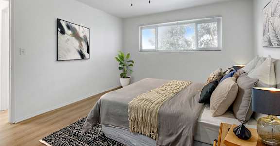 a bedroom with a large bed and a ceiling fan