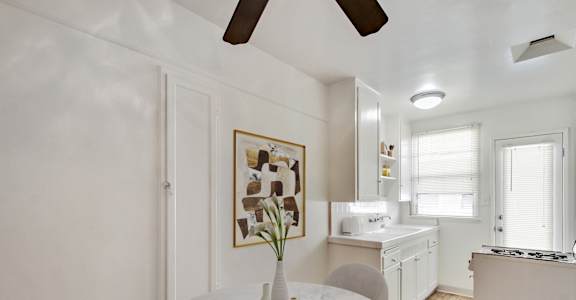 A white marble table with a vase on it in a kitchen.