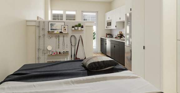 a small bedroom with a bed and a kitchen at Skylar At Sunset, Los Angeles, CA