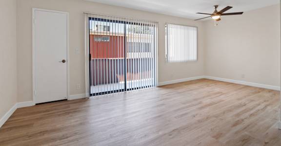 a bedroom with hardwood floors and a ceiling fan