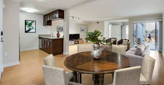 a living room and dining room with a table and chairs